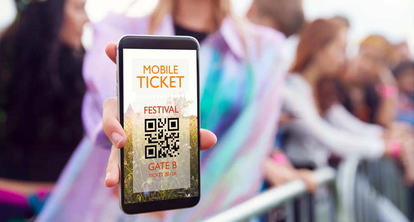 Printed event tickets held in hand