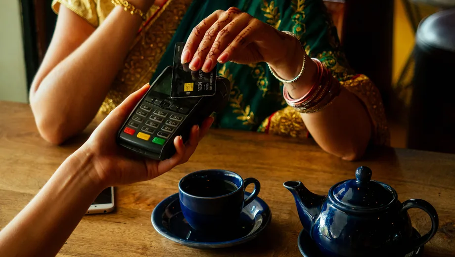 Customers using a bank ATM for card payments in India