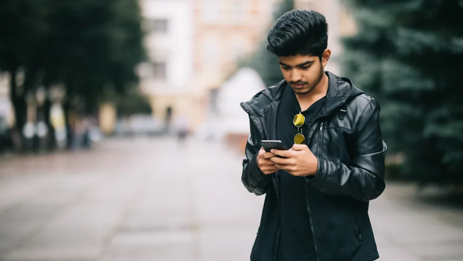 Viewer watching video on a phone while travelling