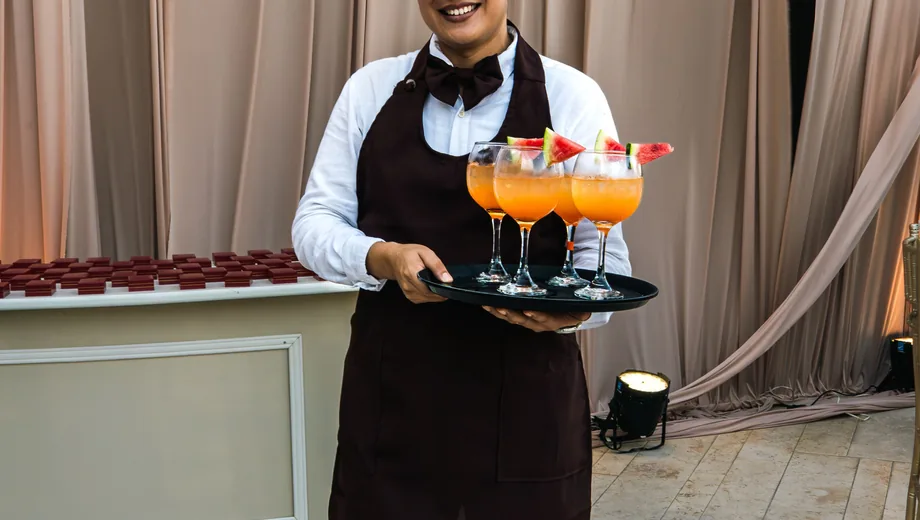 Event waiter serving drinks as freelance crew
