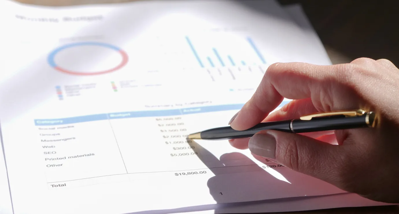 Pen over a printed quotation with cost charts