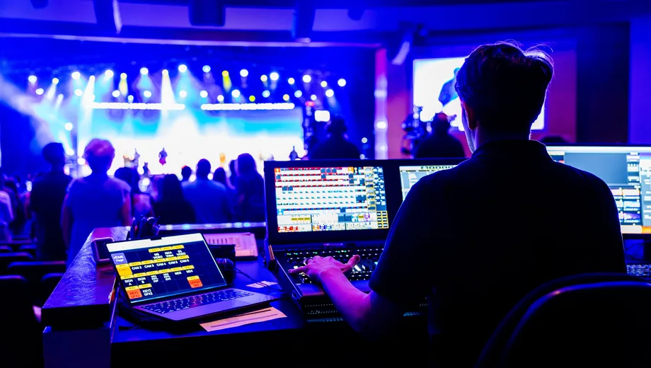 Lighting and sound desk running cues at a live event