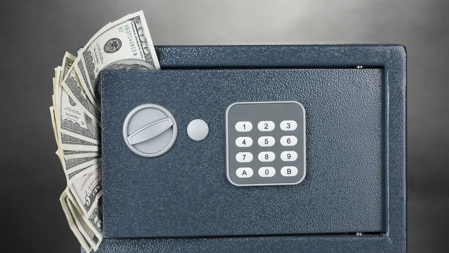 Cash held in a locked safe, standing in for withheld settlement
