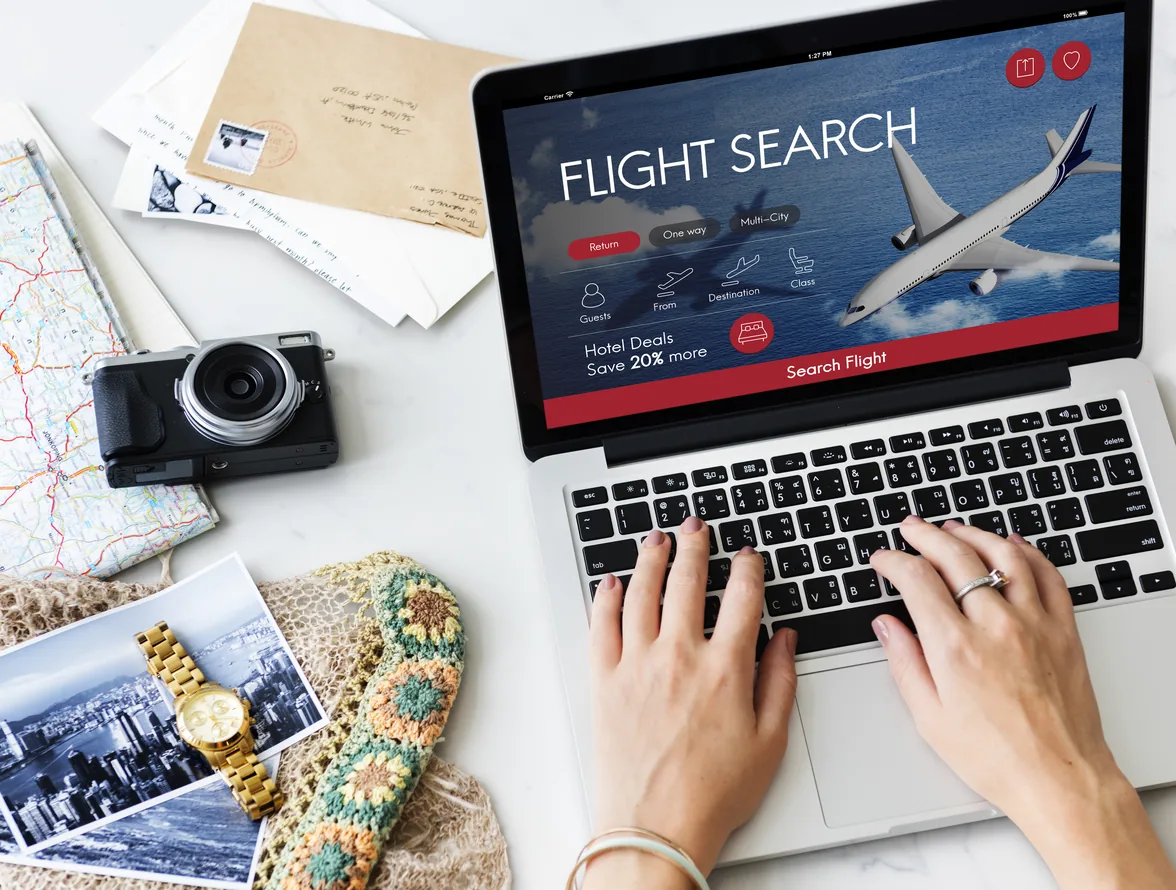 Travel itinerary and passports being planned on a tablet