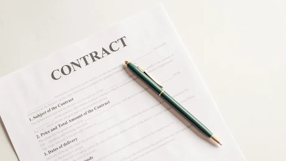 A signed vendor rate contract on a desk