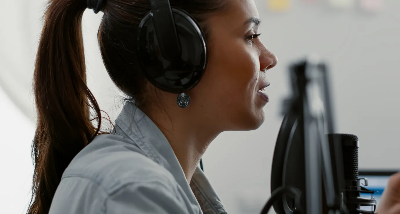 Presenter hosting a live streamed session at a microphone