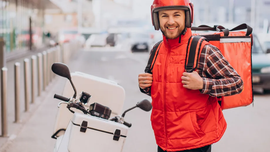 Rider setting out with a delivery bag on a scooter